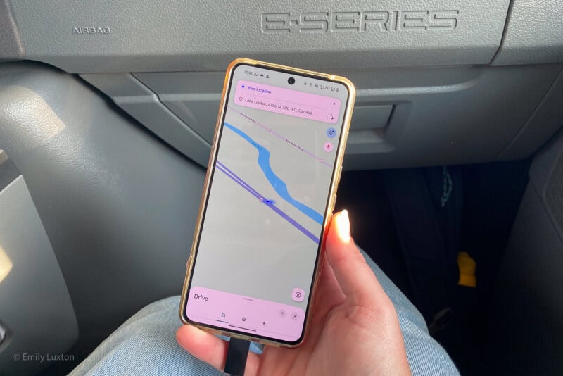 Hand holding a phone with Google Maps