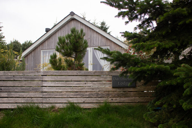 Exterior of a holioday lodge built from light grey wood
