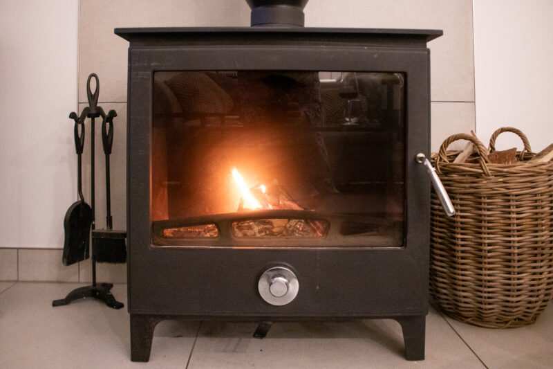 Black log burner with a fire inside