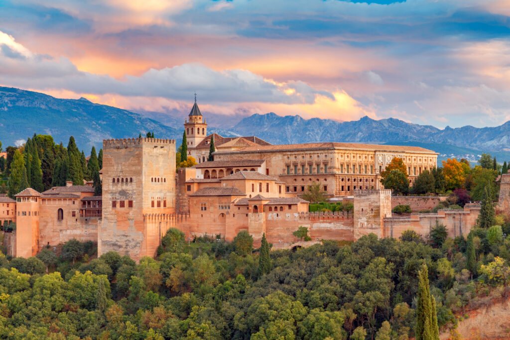Walls and towers of the fortress of the Alhambra at sunset in Granada