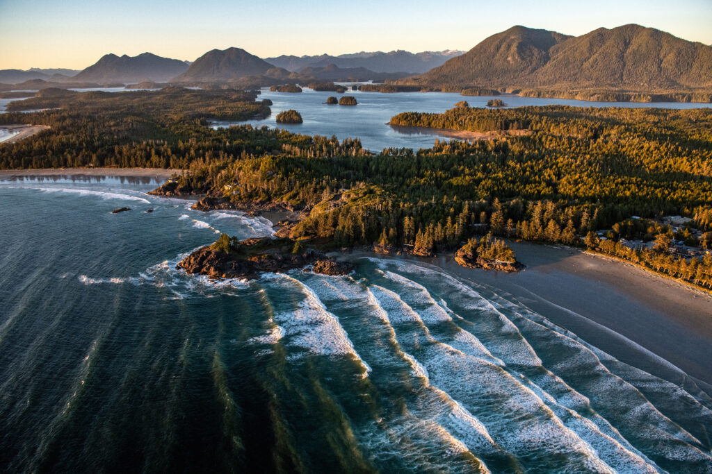 Aerial view of a landscape in Tofino covered in greenery surrounded by the sea in the Vancouver Islands, Canada