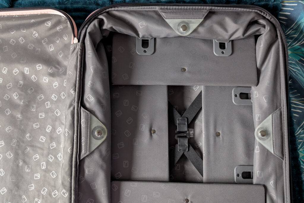 Flatlay of an open suitcase with 4 sides collapsed