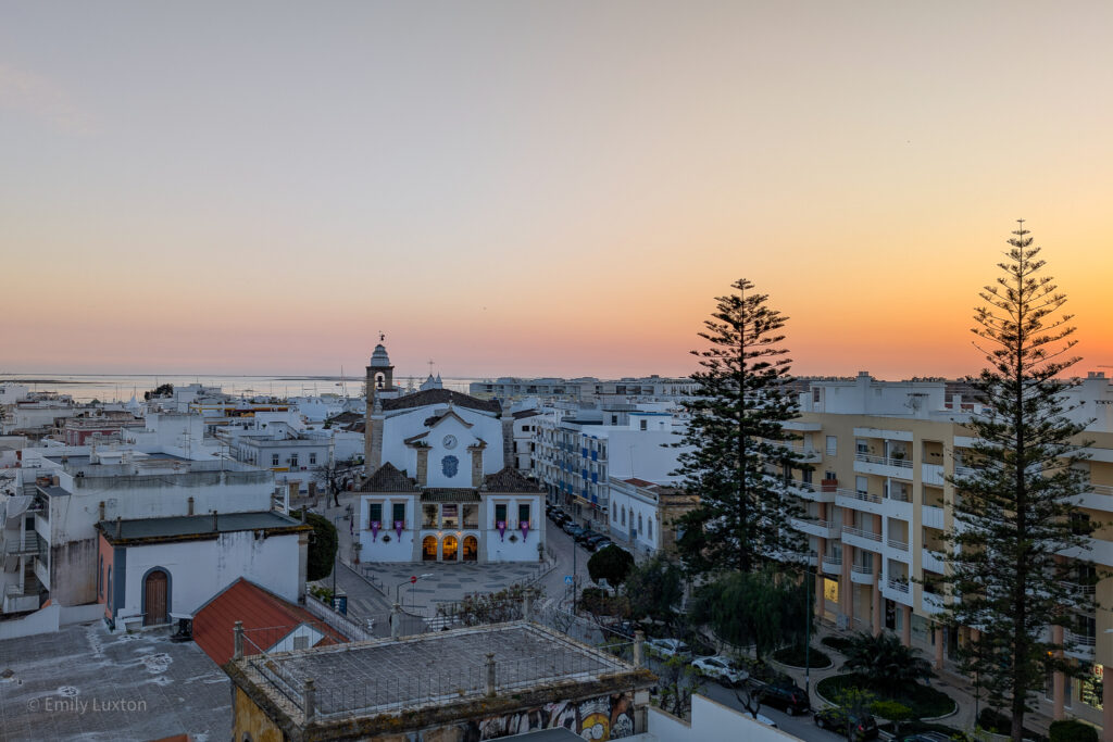 View of Olhao town centre at sunset with orange sky
