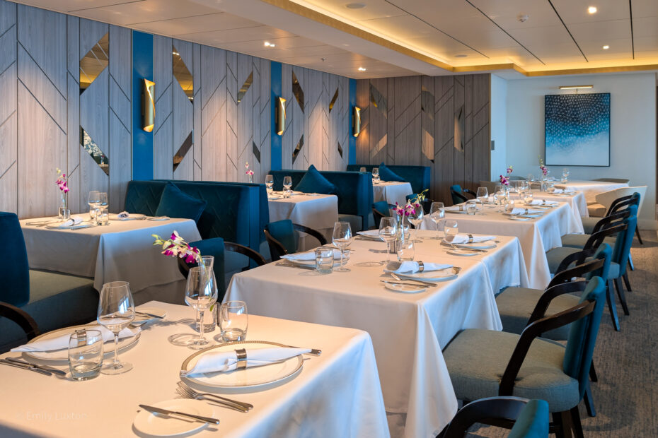 Restaurant with blue walls and tables with white tablecloths