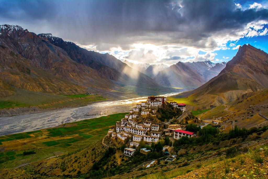 Mountain valley with a small town of white houses on a hill
