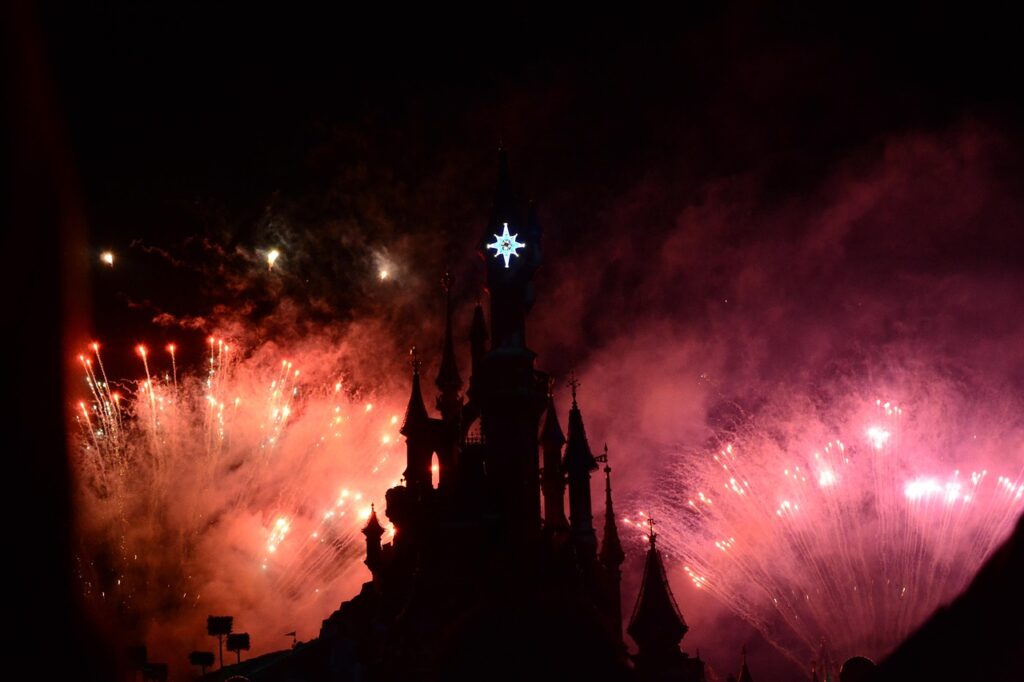 disneyland paris castle silhouetted against fireworks