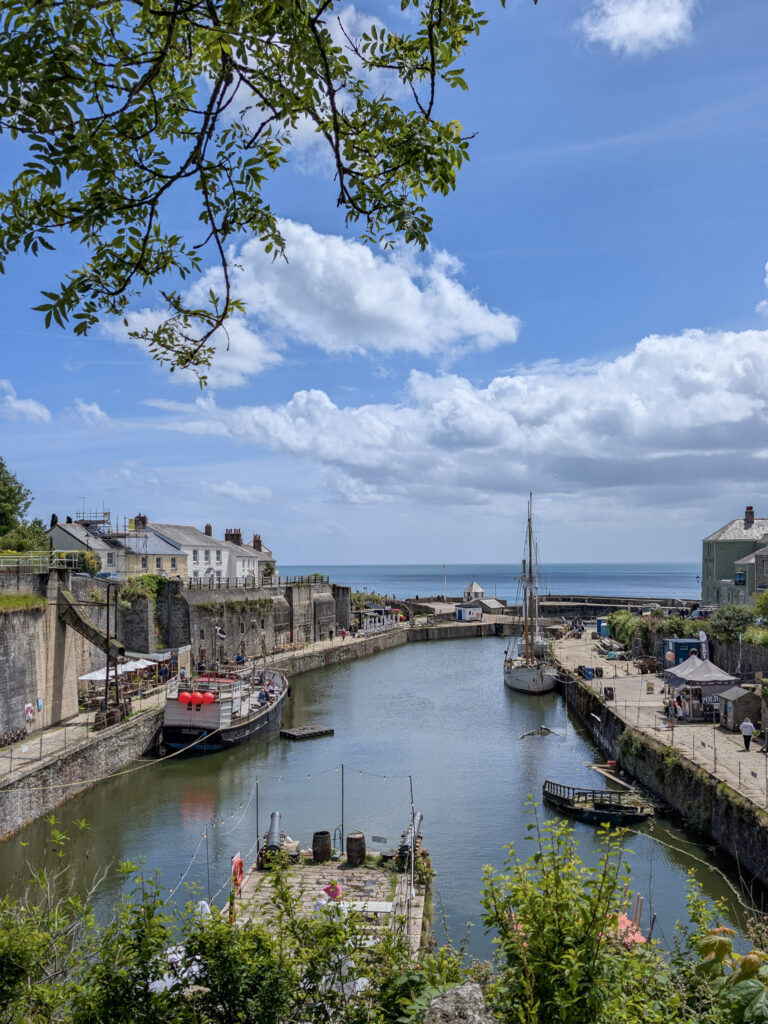 Narrow harbour with high stone walls and the sea beyond 