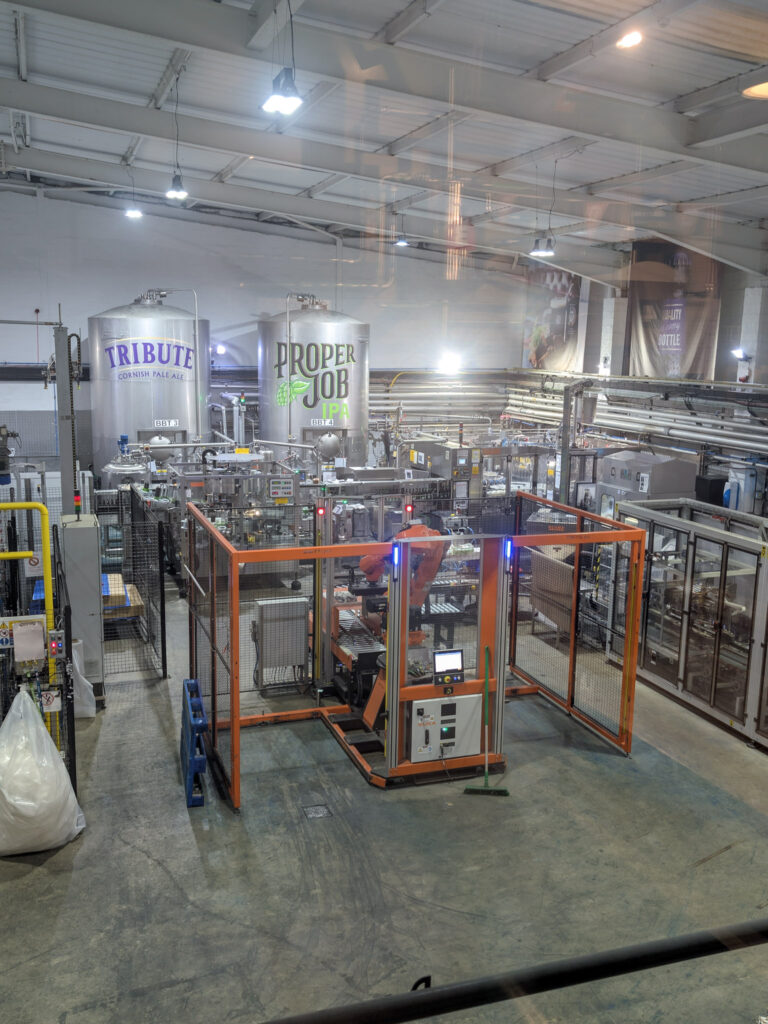 Large warehouse with metal beer brewing equipment