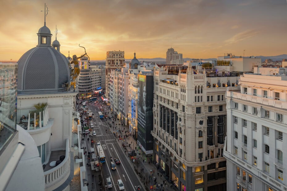 View of a city street at sunset from a rooftop in Madrid