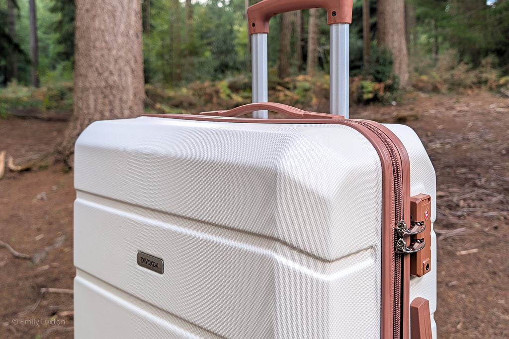 Top half of a cream suitcase with brown zips and handle | Tavoxda luggage review
